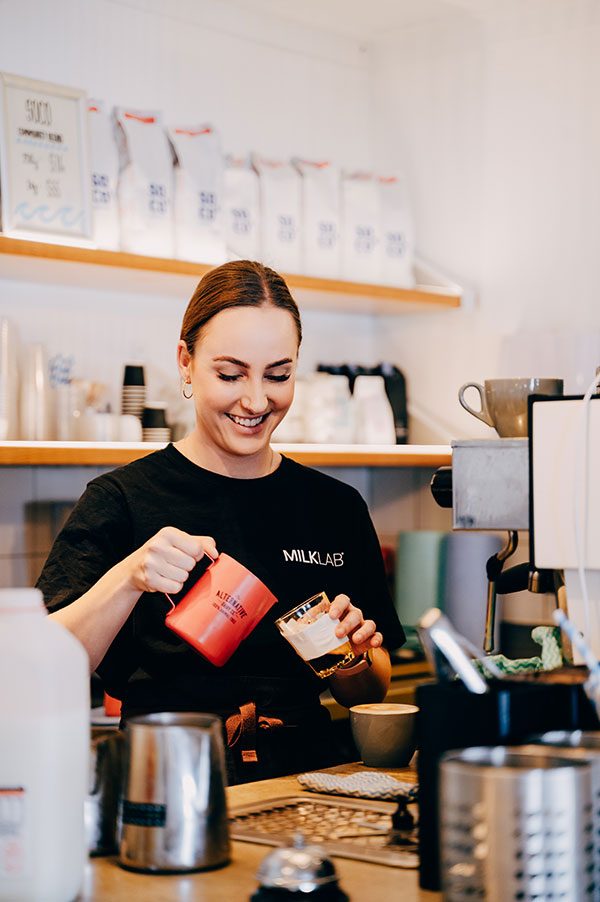 Barista pouring a coffee at Sistas
