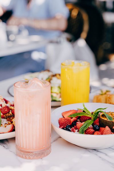 Brunch spread with smoothies and fruit bowls