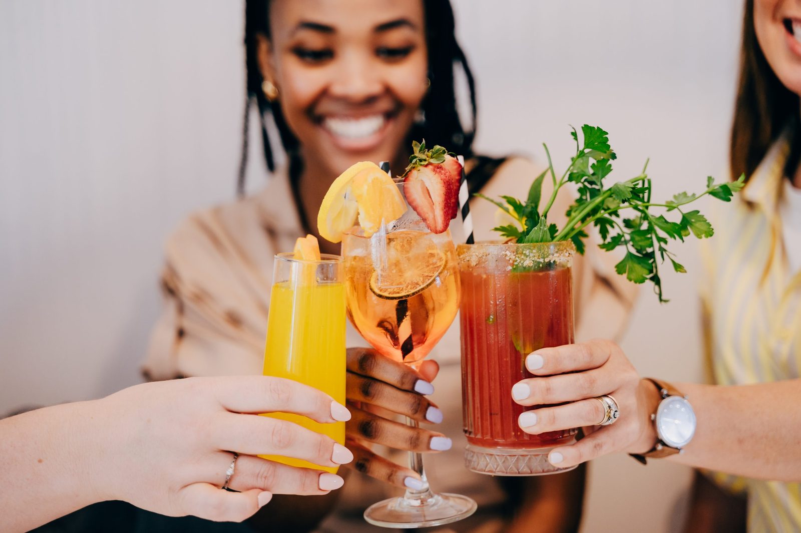 Friends toasting drinks at Sistas